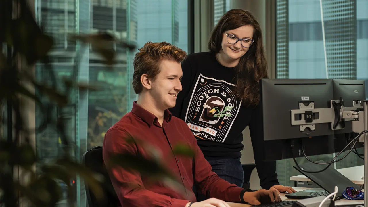 Systeemspecialist Andreea werkt samen met haar collega's op de afdeling iCAS